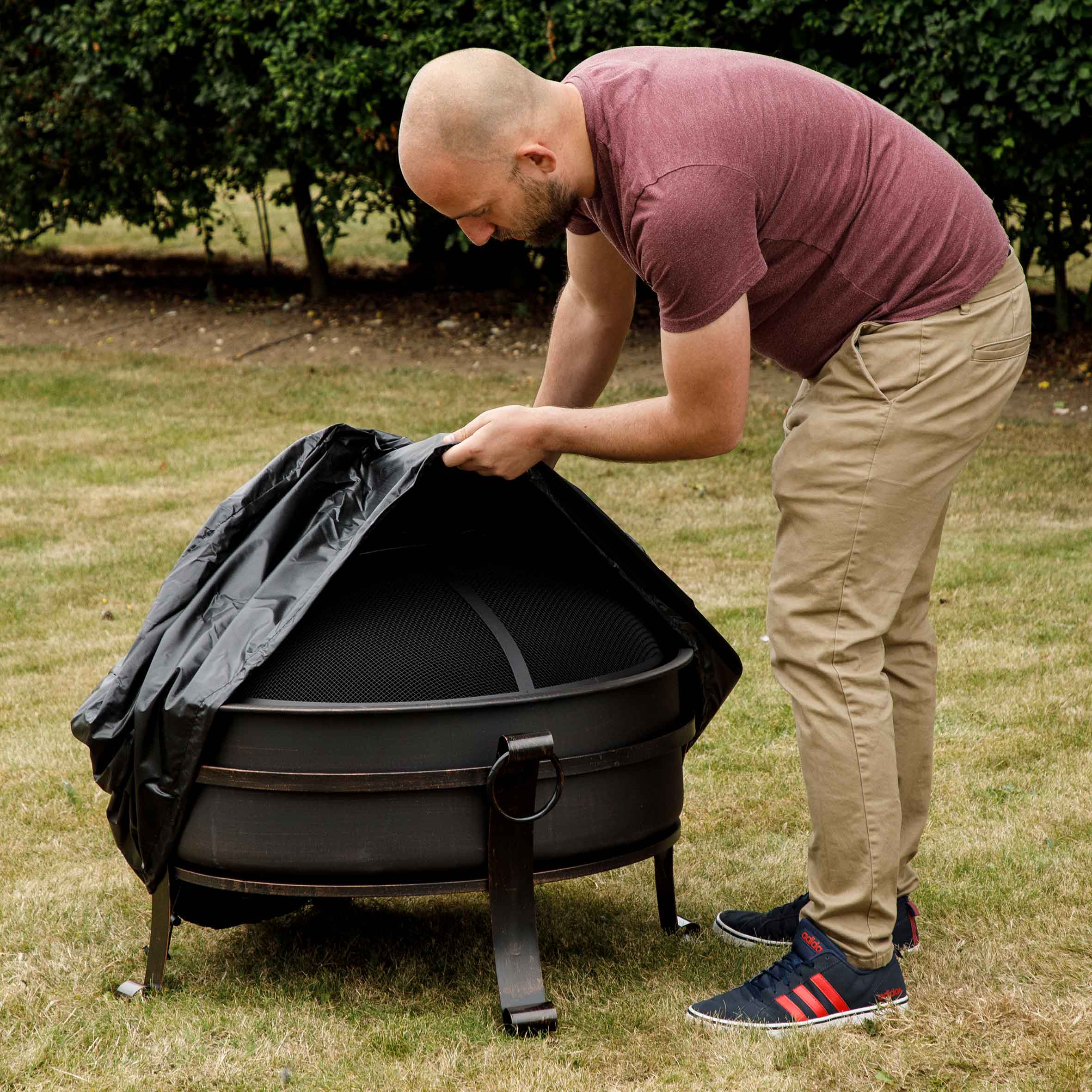 Dellonda DG118 Fire Pit Covers Action shot - putting - onto - dg42