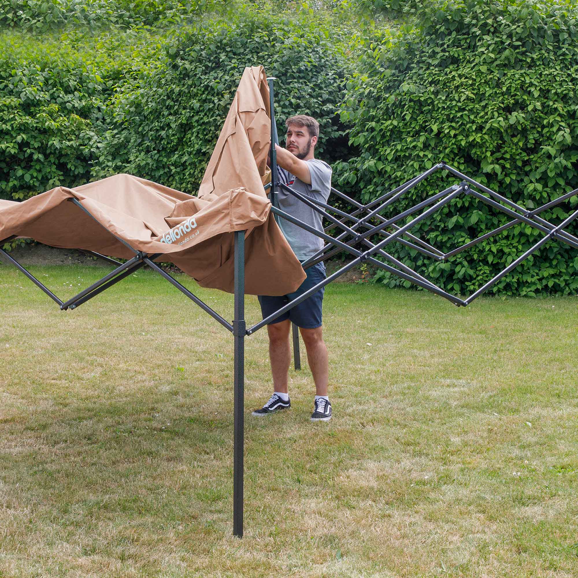 Dellonda DG126 Gazebos Action shot - putting - cover - over