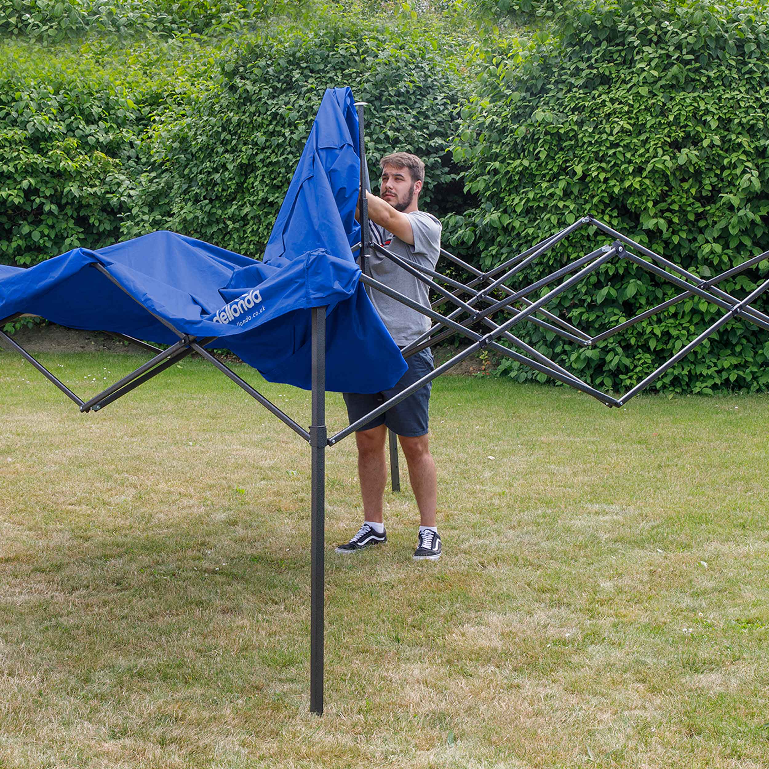 Dellonda DG131 Gazebos Action shot - putting - cover - over